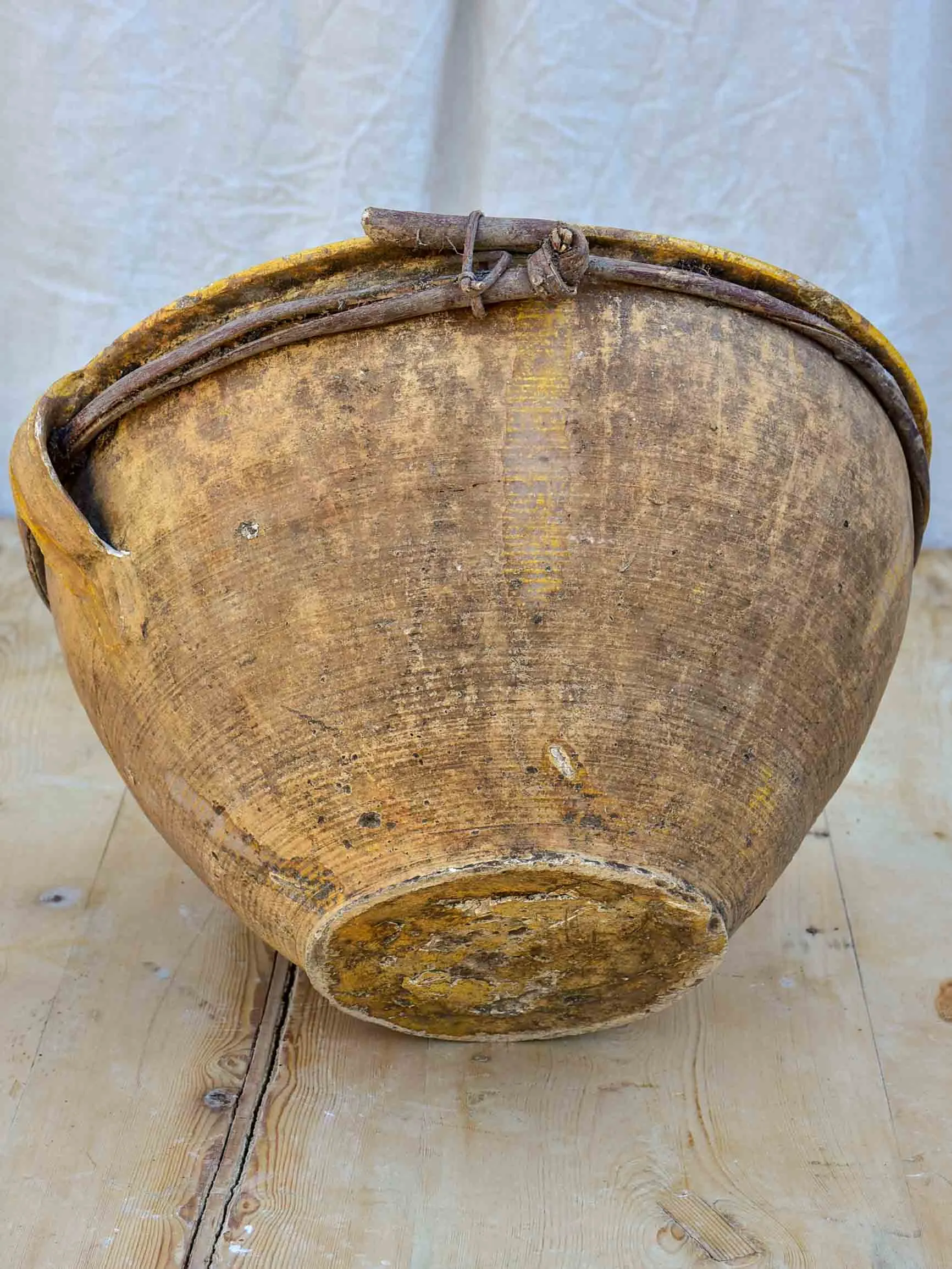 Large antique terracotta bowl with yellow glaze